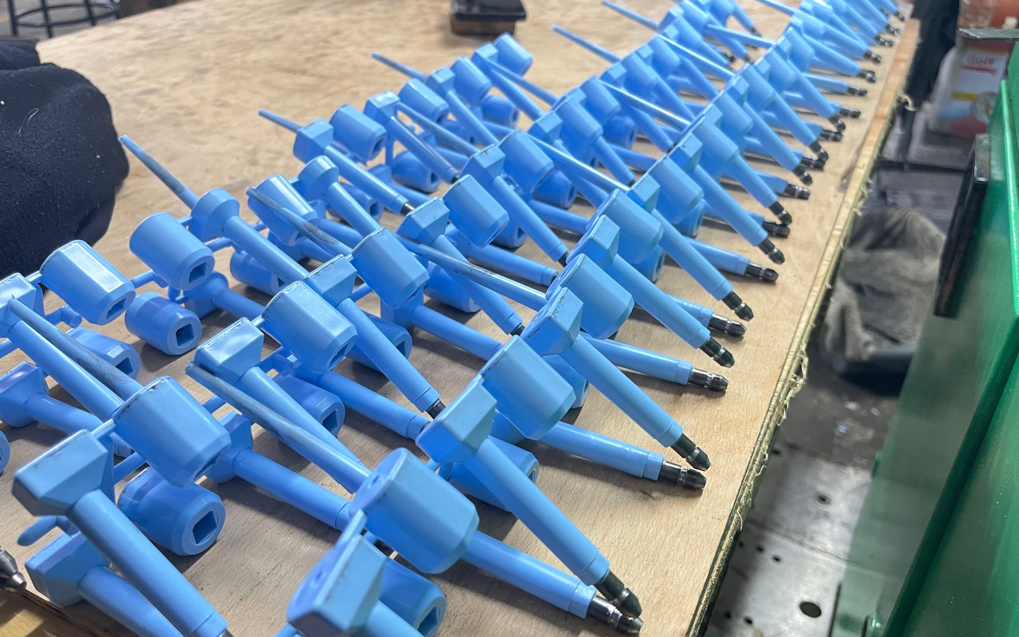 Blue bolt seals fresh from the mould, still joined to their locking bodies